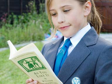 Girl looking smart in The Swanage School uniform reading a book