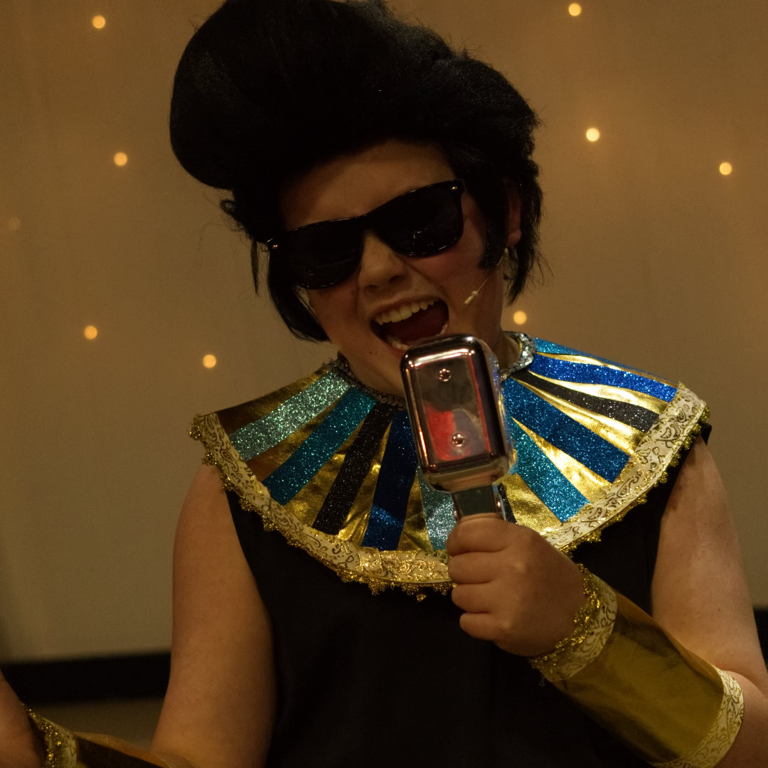 Students dressed in an Elvis wig and sunglasses portraying the Pharoah