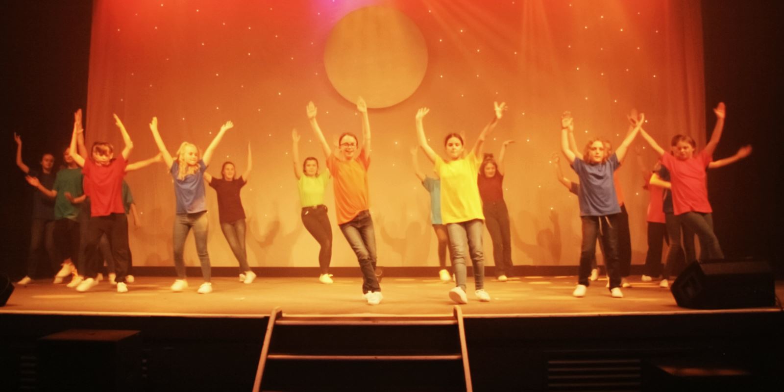 Ensemble cast dancing a hoe-down on stage in Joseph