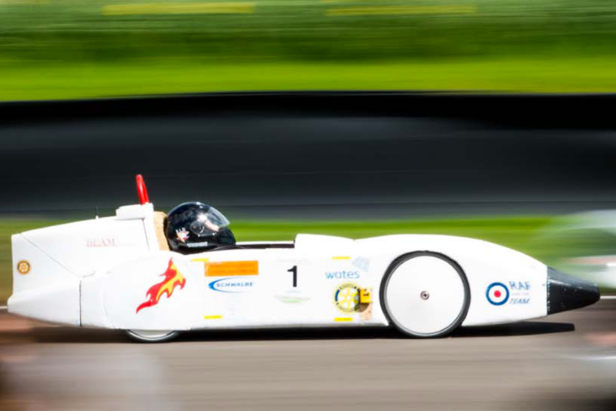 Single seat electric race car in white on a track with blurred background