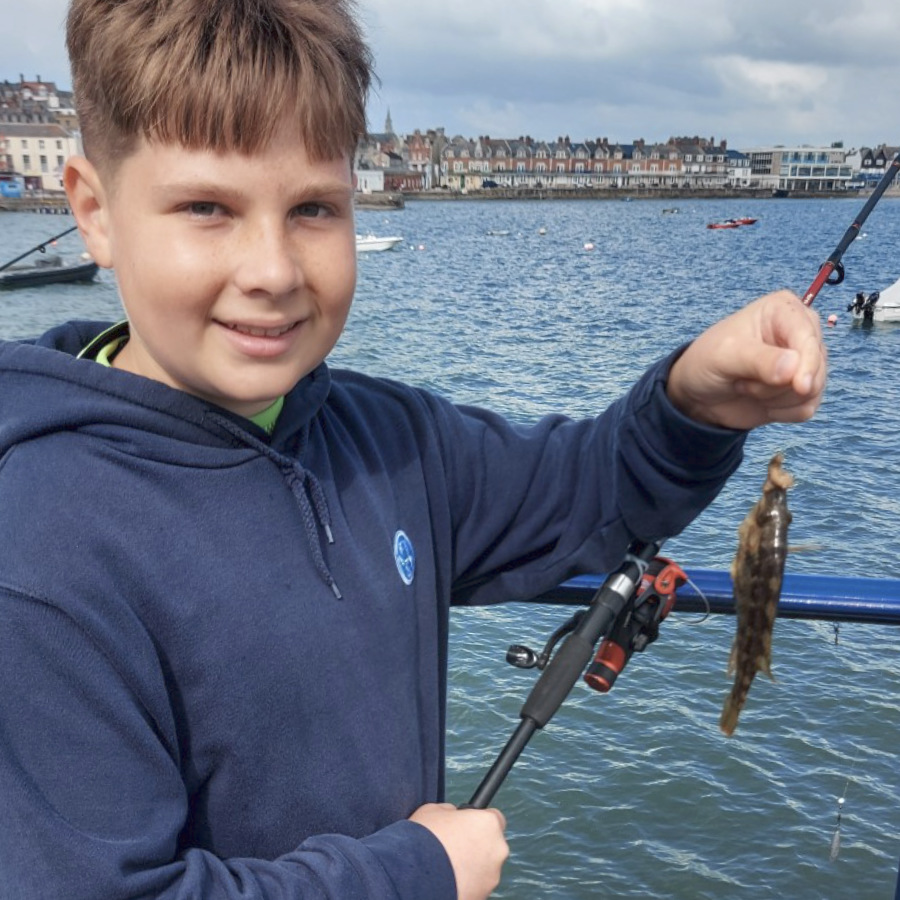 boy on the pier fishing